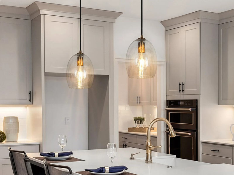 Two Slim Glass Pendants Over Kitchen Island