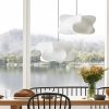 Silk Cocoon Pendant Light above dining table by window