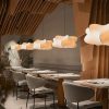 Silk Cocoon Pendant Lights lined up in restaurant setting