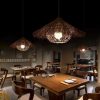 Wicker Straw Hat Pendant Light Hanging Over Restaurant Dining Table