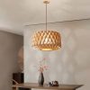 Geometric Wood Drum Pendant Light Above Dining Table in Contemporary Home