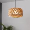 Natural Wood Geometric Drum Pendant Light Against Modern Grey Wall