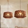 Pair of Walnut Geometric Wood Drum Pendant Lights Over Modern Dining Area