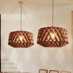 Pair of Walnut Geometric Wood Drum Pendant Lights Over Modern Dining Area