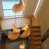 Top View of Wood Shell Shape Pendant Lights Hanging Through Double Height Stairwell