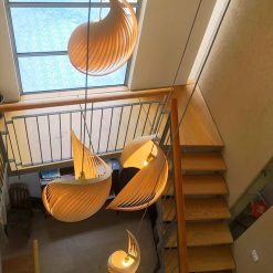 Top View of Wood Shell Shape Pendant Lights Hanging Through Double Height Stairwell