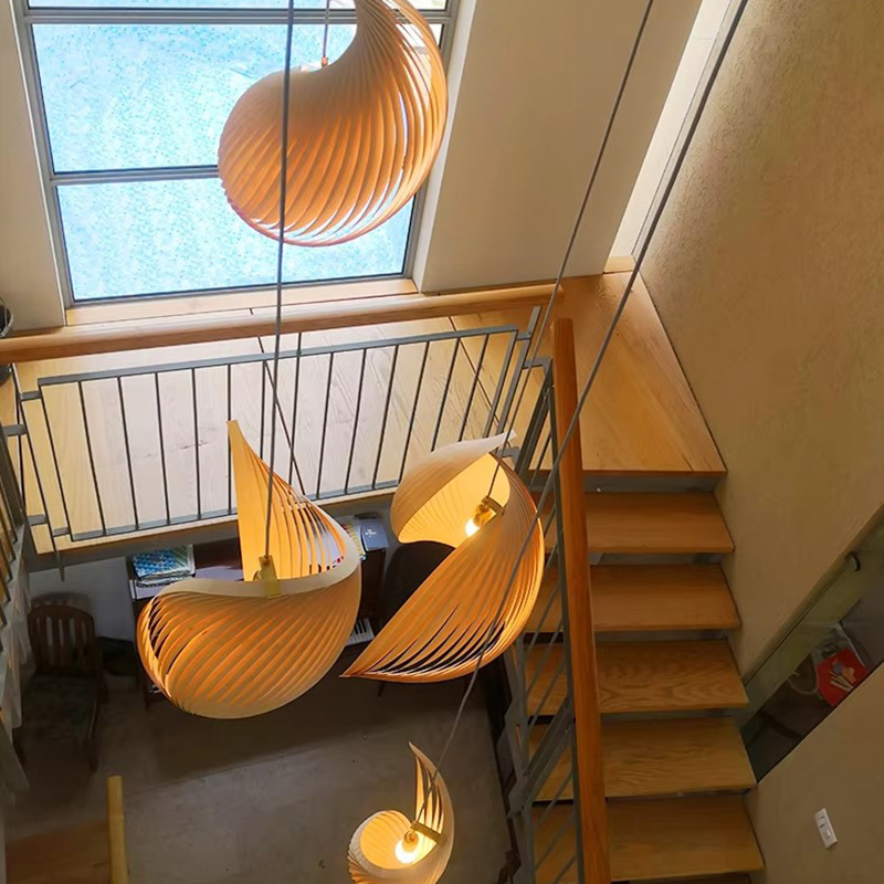 Top View of Wood Shell Shape Pendant Lights Hanging Through Double Height Stairwell