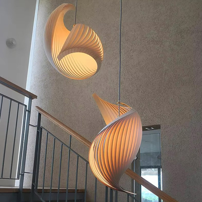 Wood Shell Shape Pendant Light with Warm Glow Beside Staircase Railing