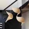 Wood Shell Shape Wooden Chandelier Over Black Staircase in Minimalist Home